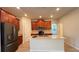 Modern kitchen featuring dark wood cabinetry, a center island, and stainless steel appliances at 4571 Tribute Trl, Kissimmee, FL 34746