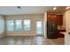 Open-concept living room with tile flooring, multiple windows, and natural light at 4571 Tribute Trl, Kissimmee, FL 34746