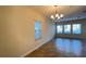 Bright living room with tile floors, ample natural light, and a decorative chandelier at 4571 Tribute Trl, Kissimmee, FL 34746
