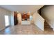 Spacious living room featuring an open layout with tile flooring, stairs and access to the kitchen at 4571 Tribute Trl, Kissimmee, FL 34746
