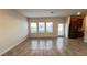 Bright living room with tile floors, natural light, and seamless access to the kitchen at 4571 Tribute Trl, Kissimmee, FL 34746