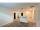 Open loft area with carpeted floors and access to multiple rooms at 4571 Tribute Trl, Kissimmee, FL 34746