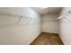 Empty walk-in closet with wire shelving and carpeted floor at 4571 Tribute Trl, Kissimmee, FL 34746