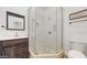 Bathroom with a glass enclosed shower, a wooden vanity, and neutral tile and decor at 4855 Lillian Black Rd, St Cloud, FL 34771