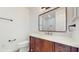 Bathroom vanity with dark wood cabinets, white countertop and bronze fixtures at 4855 Lillian Black Rd, St Cloud, FL 34771
