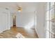 This bedroom has wood-look floors, a ceiling fan, and a double door closet at 4855 Lillian Black Rd, St Cloud, FL 34771