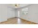 Bright bedroom with wood-look tile flooring, ceiling fan, and natural light at 4855 Lillian Black Rd, St Cloud, FL 34771