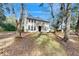 Beautiful two-story home with a balcony, arched windows, and a well-manicured lawn and mature landscaping at 4855 Lillian Black Rd, St Cloud, FL 34771