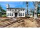 Beautiful two-story home with a balcony, arched windows, and a well-manicured lawn and mature landscaping at 4855 Lillian Black Rd, St Cloud, FL 34771