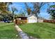 Detached two-car garage with a covered walkway and ample green space in a fenced in back yard at 4855 Lillian Black Rd, St Cloud, FL 34771