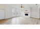 Bright living room featuring a fireplace with built-in shelving, large windows, and light hardwood floors at 4855 Lillian Black Rd, St Cloud, FL 34771