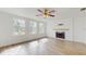 Bright living room with a fireplace, wood-look floors, and natural light at 4855 Lillian Black Rd, St Cloud, FL 34771