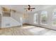 Sunlit living room featuring hardwood floors, staircase, and large arched windows at 4855 Lillian Black Rd, St Cloud, FL 34771