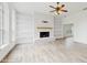 Bright living room featuring a fireplace with built-in shelving and light hardwood floors at 4855 Lillian Black Rd, St Cloud, FL 34771