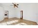 Spacious living room with hardwood floors; fireplace visible through doorway at 4855 Lillian Black Rd, St Cloud, FL 34771