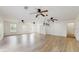 Inviting living room with wood-look tile floors, natural light, ceiling fans, and white walls at 4855 Lillian Black Rd, St Cloud, FL 34771