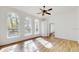 Bright living room featuring large arched windows and light hardwood floors at 4855 Lillian Black Rd, St Cloud, FL 34771