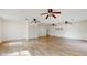 Open concept living room featuring wood-look tile floors, abundant natural light, and white walls at 4855 Lillian Black Rd, St Cloud, FL 34771