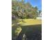 Backyard features a basketball hoop and mature trees for shade at 626 Baldwin Dr, Kissimmee, FL 34758