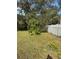 Spacious backyard features mature trees and a white fence at 626 Baldwin Dr, Kissimmee, FL 34758