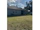 A large backyard featuring a well-maintained lawn and back view of the home at 626 Baldwin Dr, Kissimmee, FL 34758