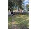 Large backyard with a stone walkway and a wooden fence at 626 Baldwin Dr, Kissimmee, FL 34758