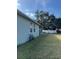 Backyard featuring a well-maintained lawn and view of side of home at 626 Baldwin Dr, Kissimmee, FL 34758