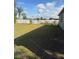 Large backyard with a well-maintained lawn and a white fence at 626 Baldwin Dr, Kissimmee, FL 34758