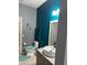 Modern bathroom with teal feature wall and vessel sink at 626 Baldwin Dr, Kissimmee, FL 34758