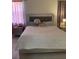 Main bedroom with large bed and silver upholstered headboard at 626 Baldwin Dr, Kissimmee, FL 34758