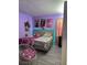 Bright bedroom with twin beds, hanging chair, and LED lighting at 626 Baldwin Dr, Kissimmee, FL 34758