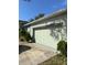 Attached two-car garage door with a clean driveway and exterior shrubbery at 626 Baldwin Dr, Kissimmee, FL 34758