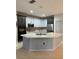 Modern kitchen with two-toned cabinets, a large island, and stainless steel appliances at 626 Baldwin Dr, Kissimmee, FL 34758