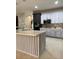 Modern kitchen with two-toned cabinets, a large island, and stainless steel appliances at 626 Baldwin Dr, Kissimmee, FL 34758