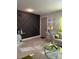 Living room with a gray accent wall and beige sofa at 626 Baldwin Dr, Kissimmee, FL 34758