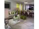 Bright living room with beige sofas, green accents, and a dining area at 626 Baldwin Dr, Kissimmee, FL 34758