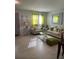 Bright living room with beige sofas, green accents, and a dining area at 626 Baldwin Dr, Kissimmee, FL 34758