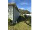 Side yard with AC unit and green bushes at 626 Baldwin Dr, Kissimmee, FL 34758