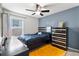 Bedroom with a queen bed, built-in dresser and ceiling fan at 6364 Domenico Ct, Groveland, FL 34736