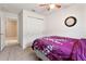 Cozy bedroom with full-size bed and window with curtains at 6364 Domenico Ct, Groveland, FL 34736