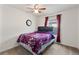 Small bedroom with full-size bed, window, and ceiling fan at 6364 Domenico Ct, Groveland, FL 34736