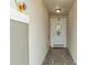 Front entry with tiled floor and a white door with glass accents at 6364 Domenico Ct, Groveland, FL 34736