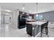 Modern kitchen with dark cabinets, island, and stainless steel appliances at 6364 Domenico Ct, Groveland, FL 34736
