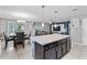 Kitchen with island, dining area, and access to the living room at 6364 Domenico Ct, Groveland, FL 34736