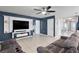 Bright living room with a large TV, comfortable seating and neutral color palette at 6364 Domenico Ct, Groveland, FL 34736
