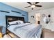 Main bedroom with king-size bed, ensuite bathroom access, and ceiling fan at 6364 Domenico Ct, Groveland, FL 34736
