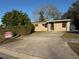 Inviting tan single-story home featuring a concrete driveway, neat landscaping, and a 'For Sale by Owner' sign at 701 N 4Th St, Haines City, FL 33844