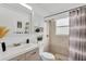 Bathroom with a bright vanity, a modern commode, and a tiled shower at 7933 Merrimac Cove Dr, Orlando, FL 32822