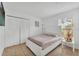 Bright bedroom features a white bed frame and a large closet with louvered doors at 7933 Merrimac Cove Dr, Orlando, FL 32822