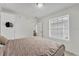Bedroom with a queen bed, neutral walls, and a window with blinds at 7933 Merrimac Cove Dr, Orlando, FL 32822